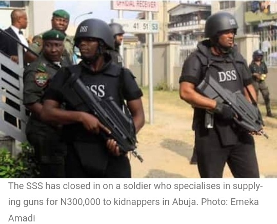 Nigeria  Soldier Who Supplies Guns to Abuja Kidnappers for N300K Nabbed by SSS, Vigilante Group    Operatives of Nigeria’s secret police have closed in on a solider who specialises in supplying guns to kidnappers in Abuja The State Security Service successfully nabbed the erring soldier with collaboration from members of the local vigilante group in Dankogi Park, Zuba area According to security sources, the soldier usually hires his guns for N300,000 to these kidnappers who hunt their victims in Abuja and its environs.  The State Security Service has arrested a soldier attached to the Muhammadu Buhari cantonment in Tungan-Maje area of Abuja, Nigeria’s capital city for allegedly supplying guns to kidnappers in the Federal Capital Territory.    Reports from the secret police revealed that the soldier whose name was withheld allegedly hires and sells guns to the kidnappers who operate in Abuja.   The SSS confirmed that the soldier’s arrest followed joint operations between some operatives of the secret police and members of the vigilante group in Dankogi Park, Zuba area. The source noted that the soldier was arrested last week as the leadership of the secret police in Gwagwalada area of the FCT had sought the assistance of the local office following a series of previous arms allegations against him, the soldier in his first deal had hired out a gun for a kidnap operation for N300,000. Details of the soldier’s investigation and arrest Investigation on the soldier began after some kidnappers  in the SSS custody made revealed his role in their activities. The source added when speaking with Quicktvafrica : “Then in the second instance, they contacted him for another deal and he demanded N200,000 which the kidnappers allegedly paid, but he failed to produce the guns   So they contacted him for another deal to supply them with AK-47s to buy at the cost of N3 million. “We went to the agreed site on the delivery day here in Zuba, and took position. He arrived at the scene in his car to present the arm, and that was the time we came out and caught him with the gun well wrapped.’’ Recoveries made from the soldier Following this, some of the items recovered from the soldier include an AK-47, a fully loaded magazine with 30 rounds of ammunition which was found inside one of the safe compartments of the soldier’s car. The source said: “We drove him to our office where a document was signed with the DSS and handed him over to them.” Some officers from the Nigerian Army Headquarters in Abuja later met with vigilantes in their Zuba office where they took statements on how the operation against the soldier was successfully carried out
